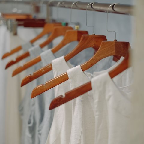 Wooden hangers on the studio rail