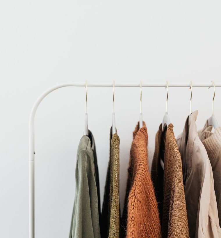 A tailored jacket and wide trousers on a rail