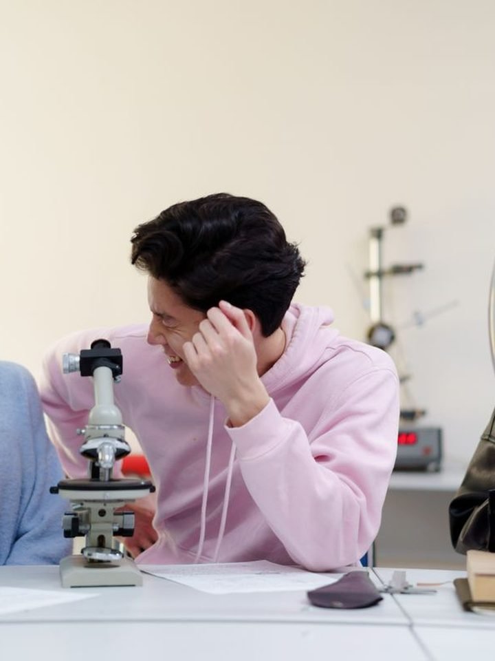A student at a microscope in the science lab